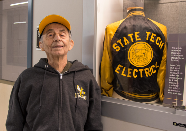 Louis Cane standing next to his donated State Tech Electrical jacket