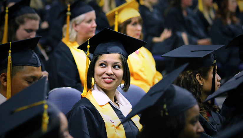 2014 Graduate smiling at commencement