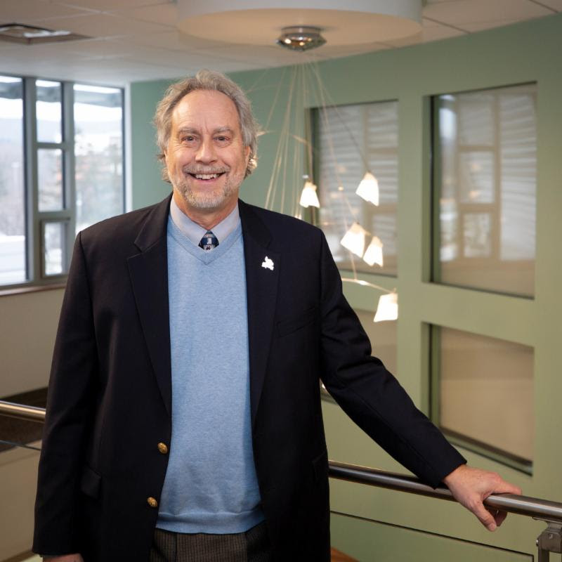 Dr. Kevin E. Drumm standing in a hallway on campus.