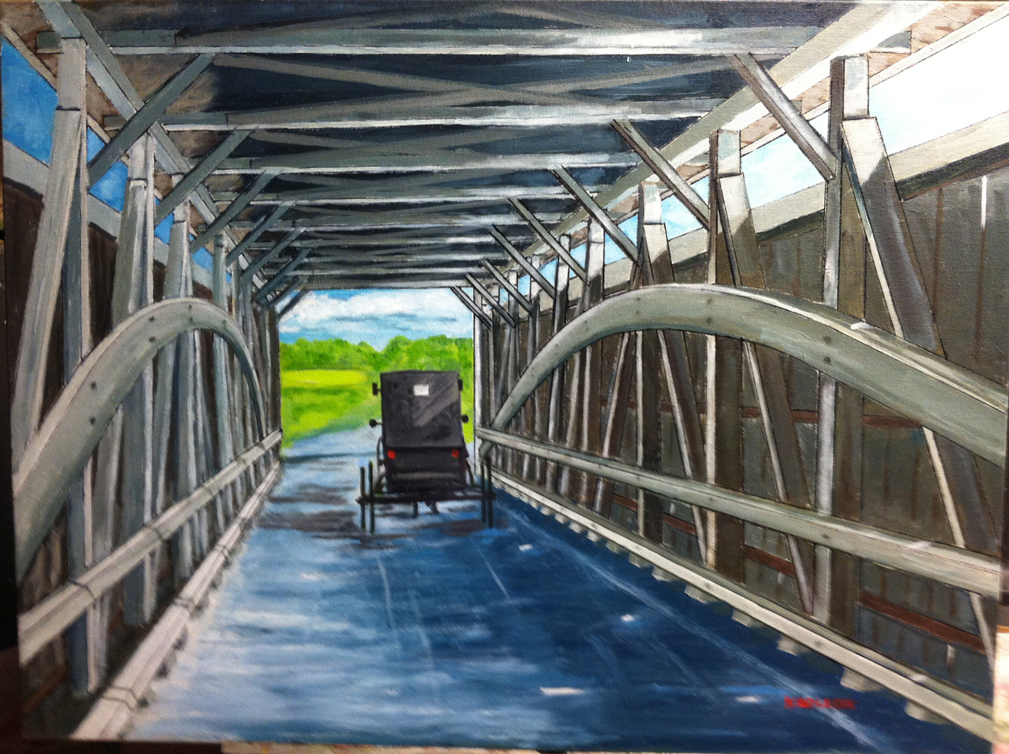 An Amish buggy rolling down a covered bridge.