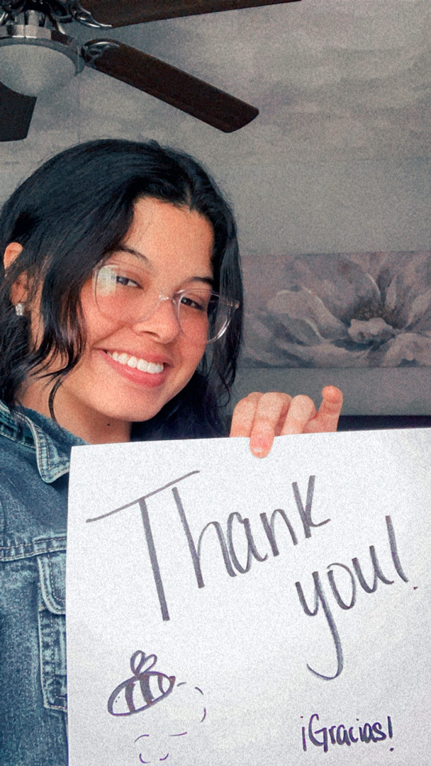 Jeidimarie Rios  holds a sign that says 'thank you'