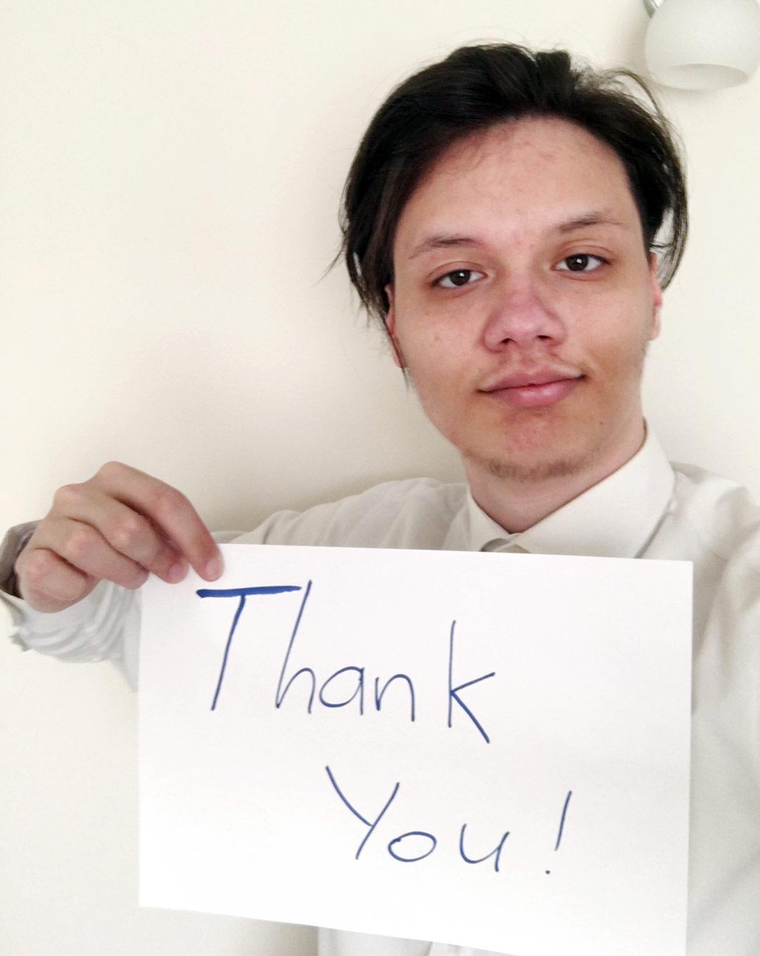 Makarii Yurkiv holds a sign that says 'thank you'