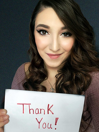 Brandy holds up a thank you sign.