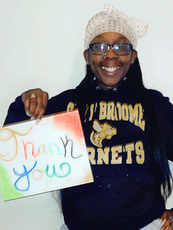 Errica holds up a thank you sign.