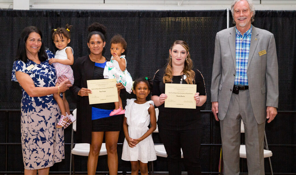 Photo of two students receiving scholarships at the Scholarship Reception 2022.