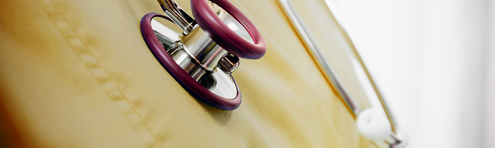 Close-up of yellow scrubs and a stethoscope
