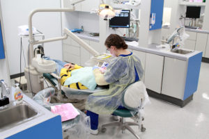Student performing dental check on a patient