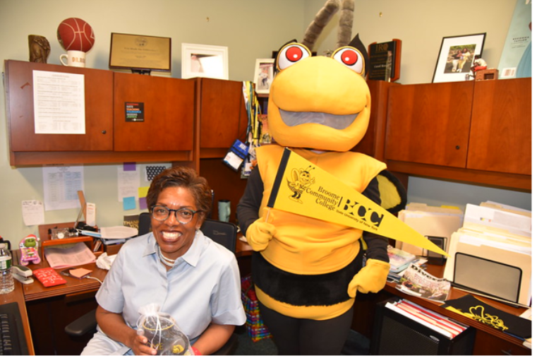 Dr Carol Ross-Scott n her office with the SUNY Broome Hornet mascot