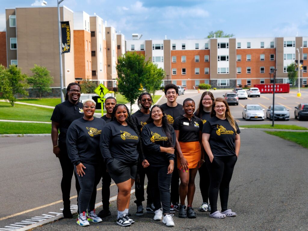 Resident Assistant staff for 2023-2024 academic year posing in front of the SUNY Broome residence hall.